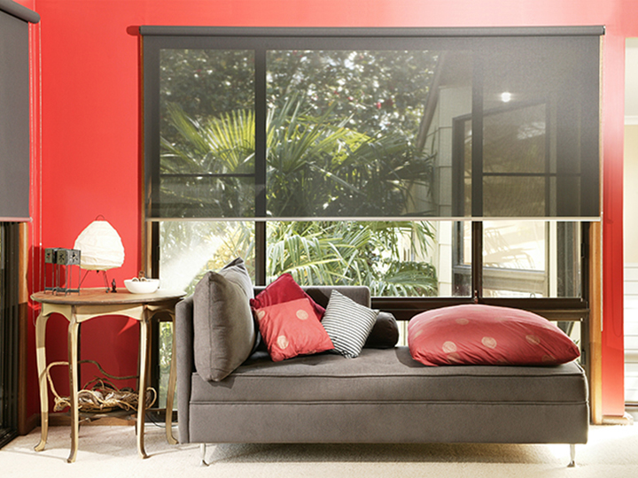 red interior room with a tan sofa an awning shade